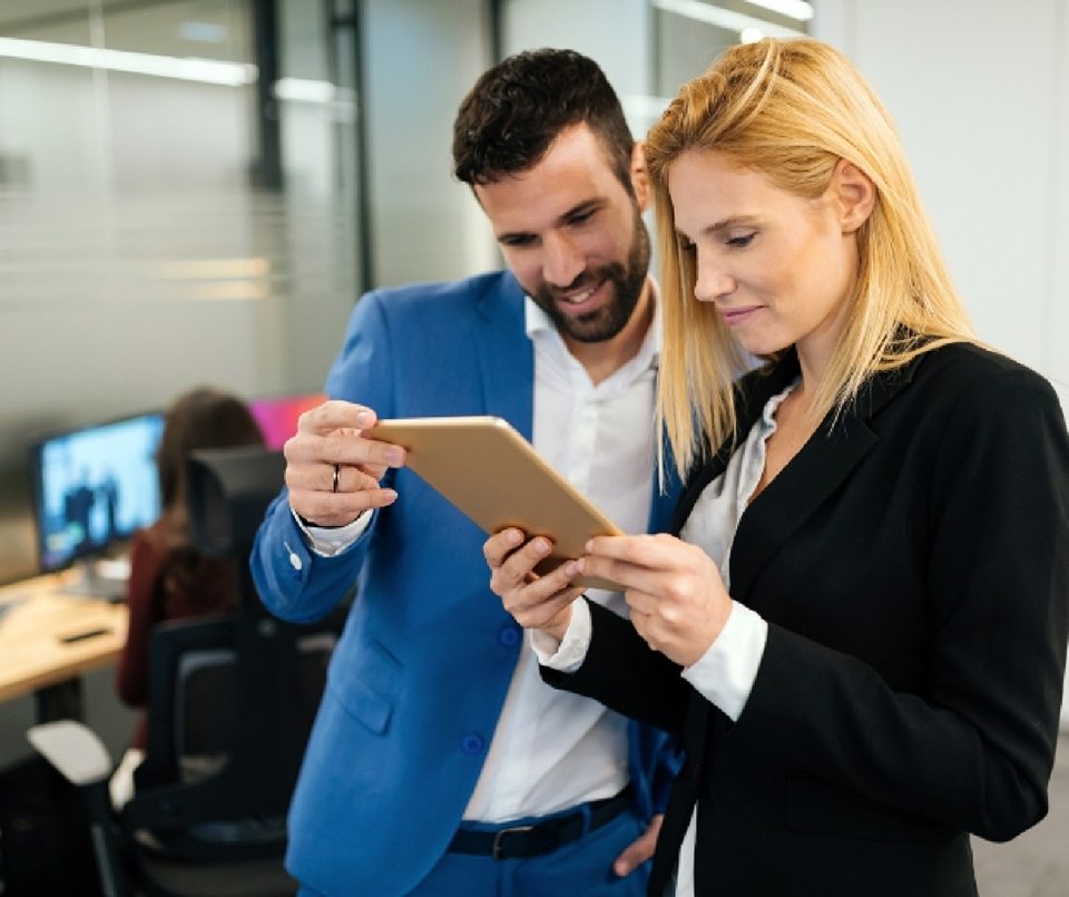 businesspeople-discussing-while-using-digital-WFGVC3X@2x