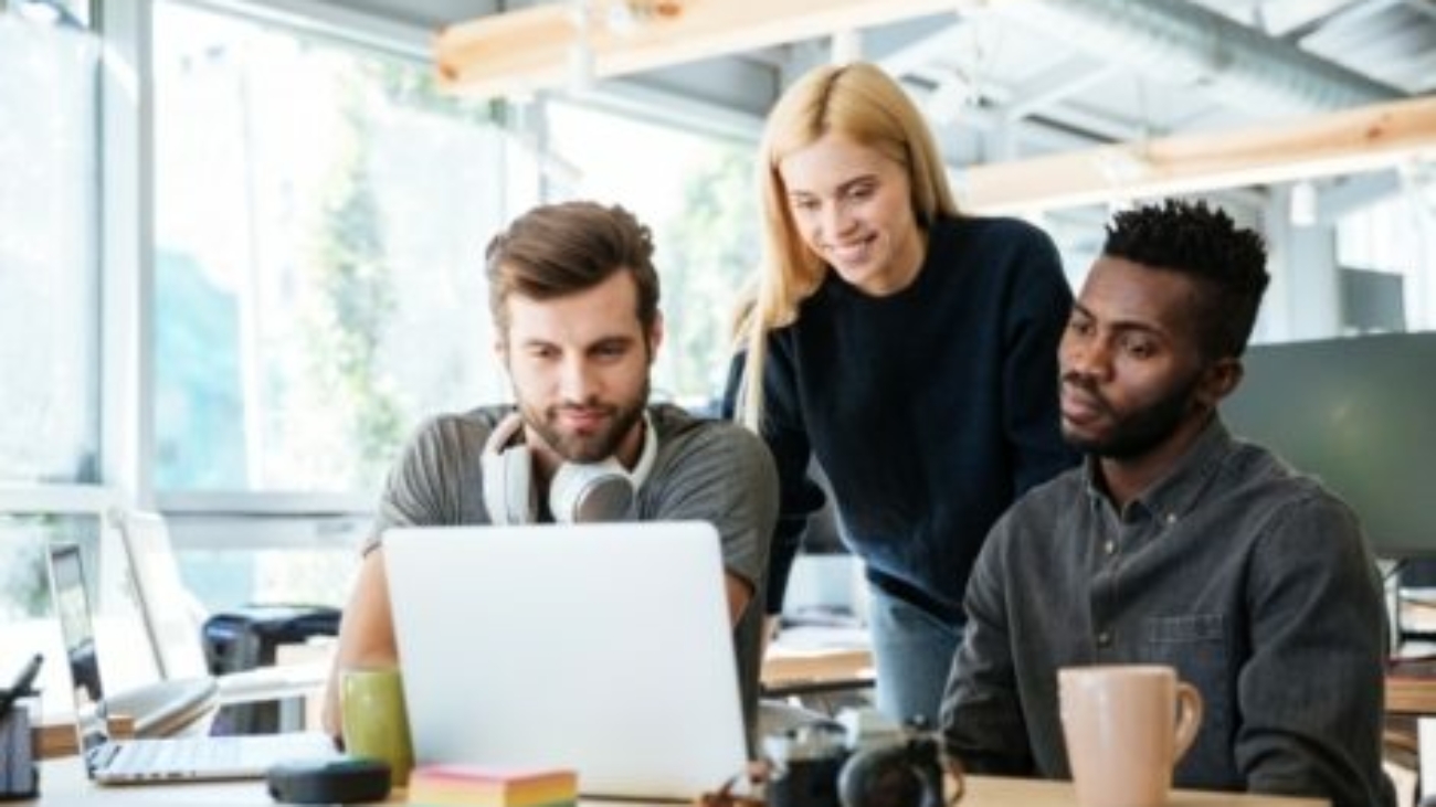 happy-colleagues-sitting-in-office-coworking-PHYA6TG-470x318