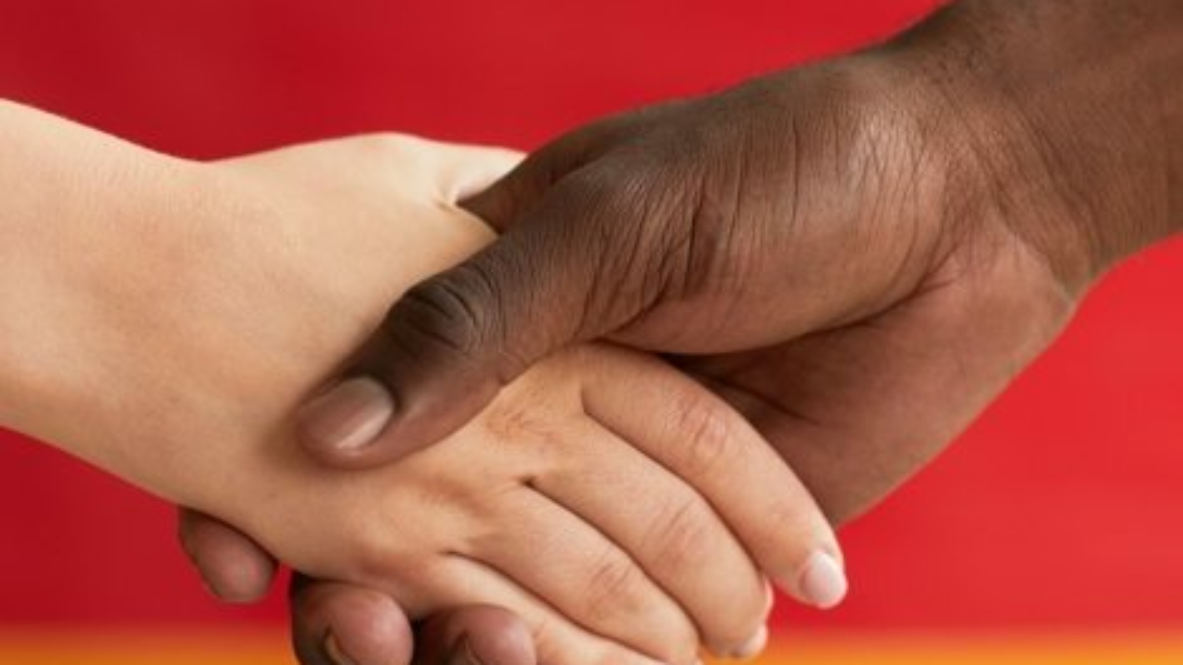 Close-up of people shaking hands against the German flag