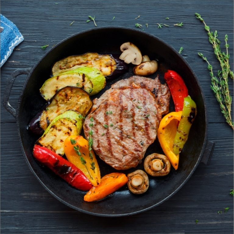 grilled-beef-steak-on-dark-wooden-table-P4NLM25-768x768
