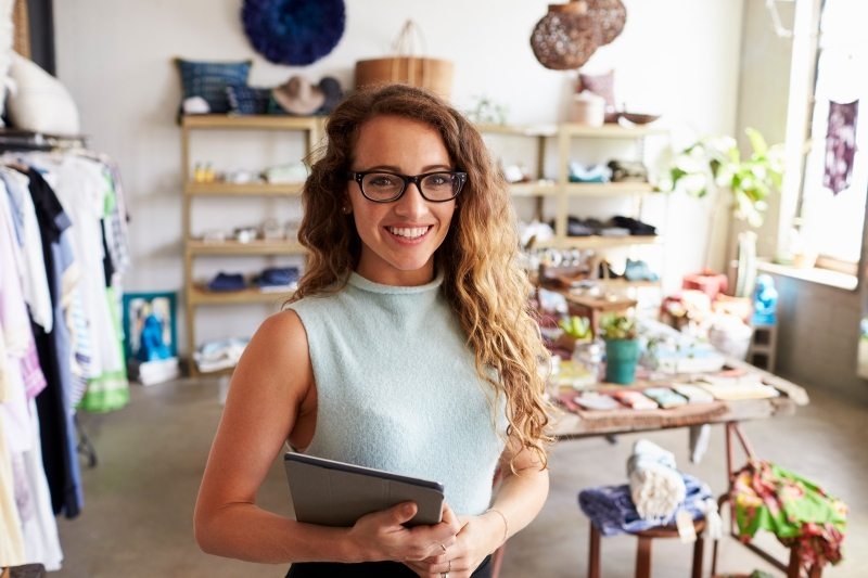 female-business-owner-holding-tablet-computer-in-PEVERD4-800x533