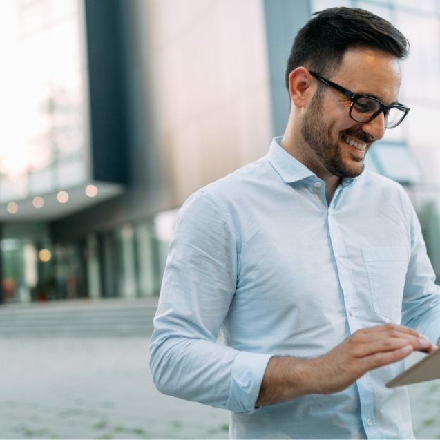 portrait-of-businessman-in-glasses-holding-tablet-AWVHCJU-637x637